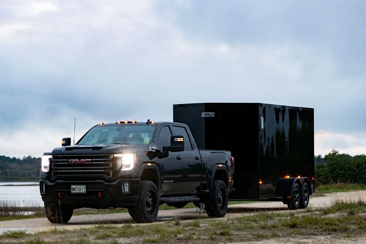 Black GMC Lugging Black Trailer