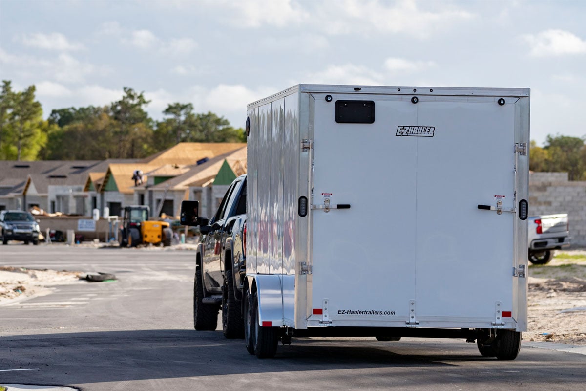 Black GMC Lugging White Trailer